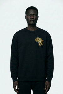 Person wearing a black sweatshirt with a gold graphic design on a white background