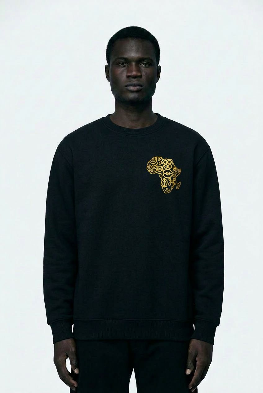 Person wearing a black sweatshirt with a gold graphic design on a white background