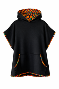 Black poncho with colorful geometric patterned hood on a white background