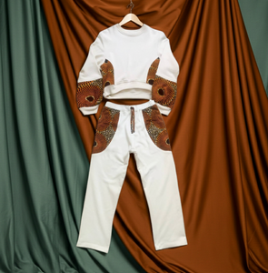 White sweatshirt and pants with brown animal print on a hanger against a draped fabric background