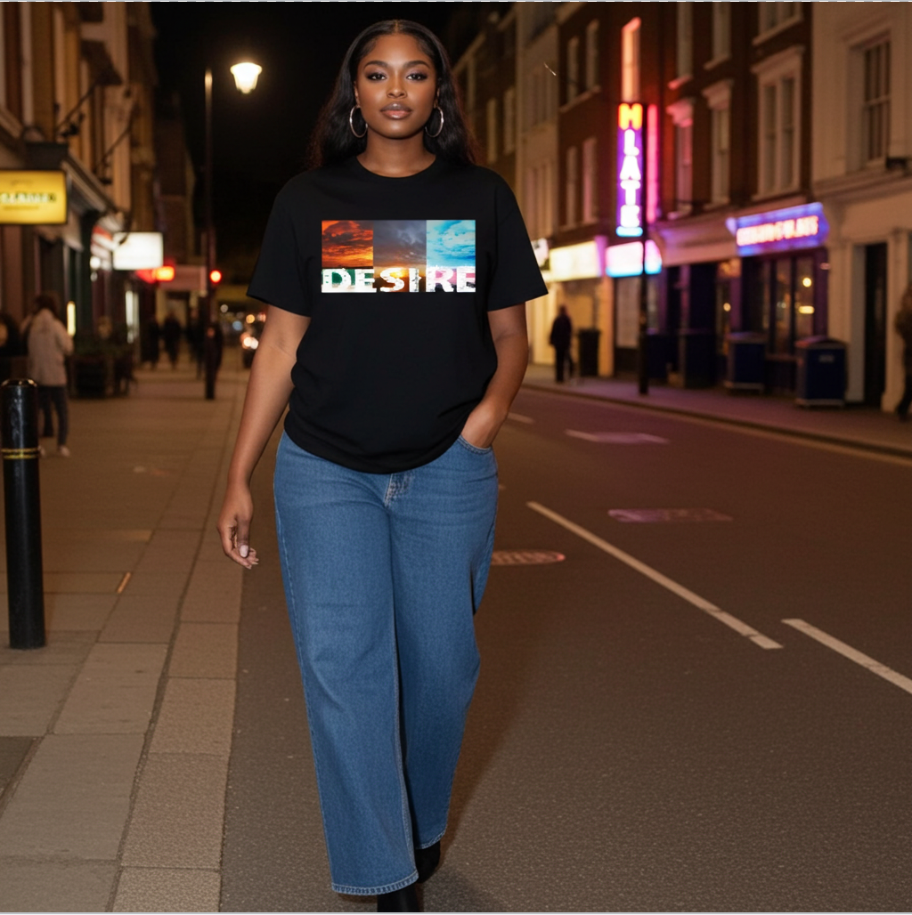 Person wearing a black t-shirt with 'DESIRES' printed on it, standing on a city street at night.