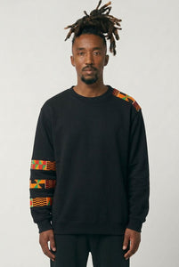 Man wearing a black sweatshirt with colorful patterns on sleeves against a white background