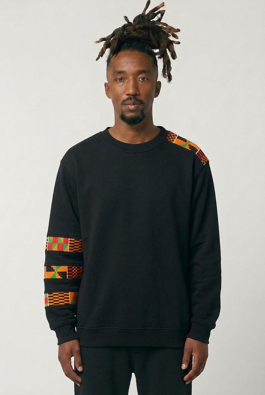 Man wearing a black sweatshirt with colorful patterns on sleeves against a white background