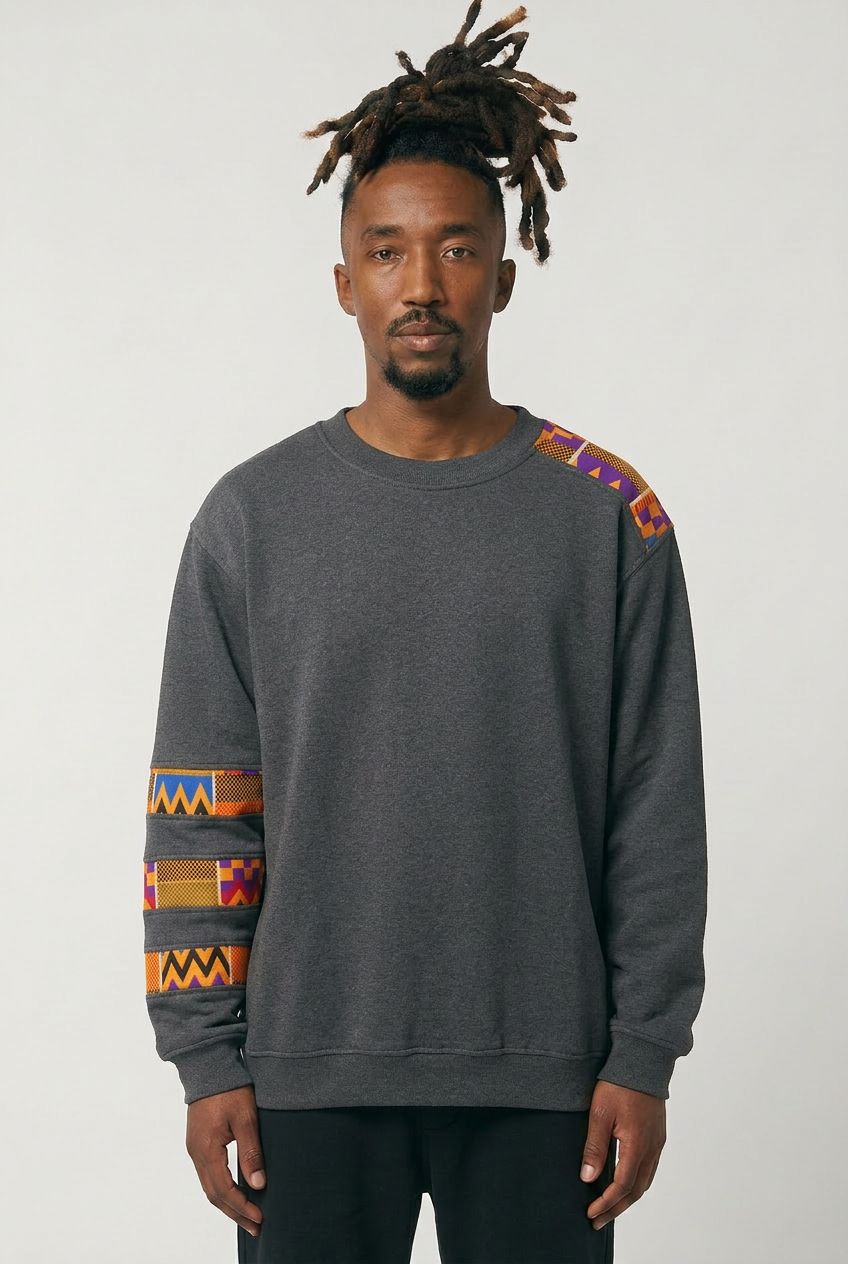 Man wearing a dark gray sweatshirt with colorful geometric patterns on sleeves against a white background