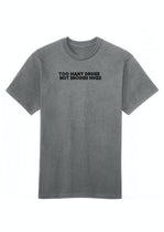 A gray cotton crew neck t-shirt with the text 'TOO MANY DRUGS NOT ENOUGH HUGS' printed on the front.