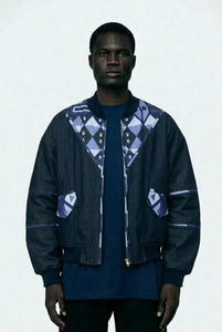 Man wearing a dark jacket with geometric patterns on a white background