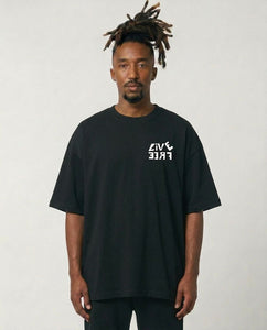 Man wearing a black t-shirt with a logo on a plain background