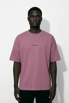 Man wearing a pink t-shirt with text on a white background
