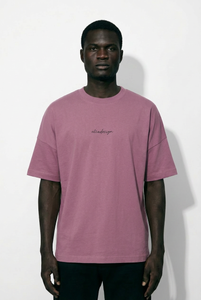 Man wearing a pink t-shirt with text on a white background