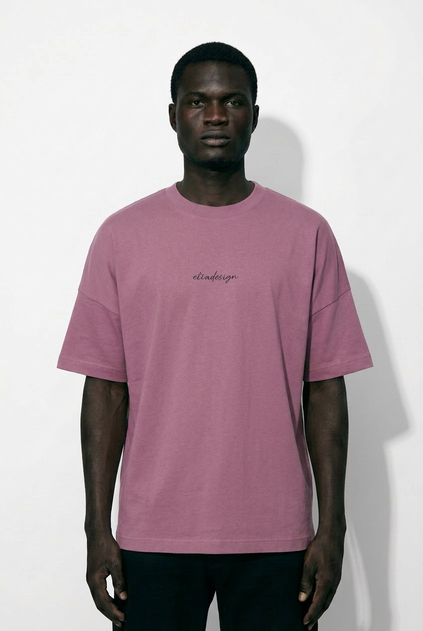 Man wearing a pink t-shirt with text on a white background