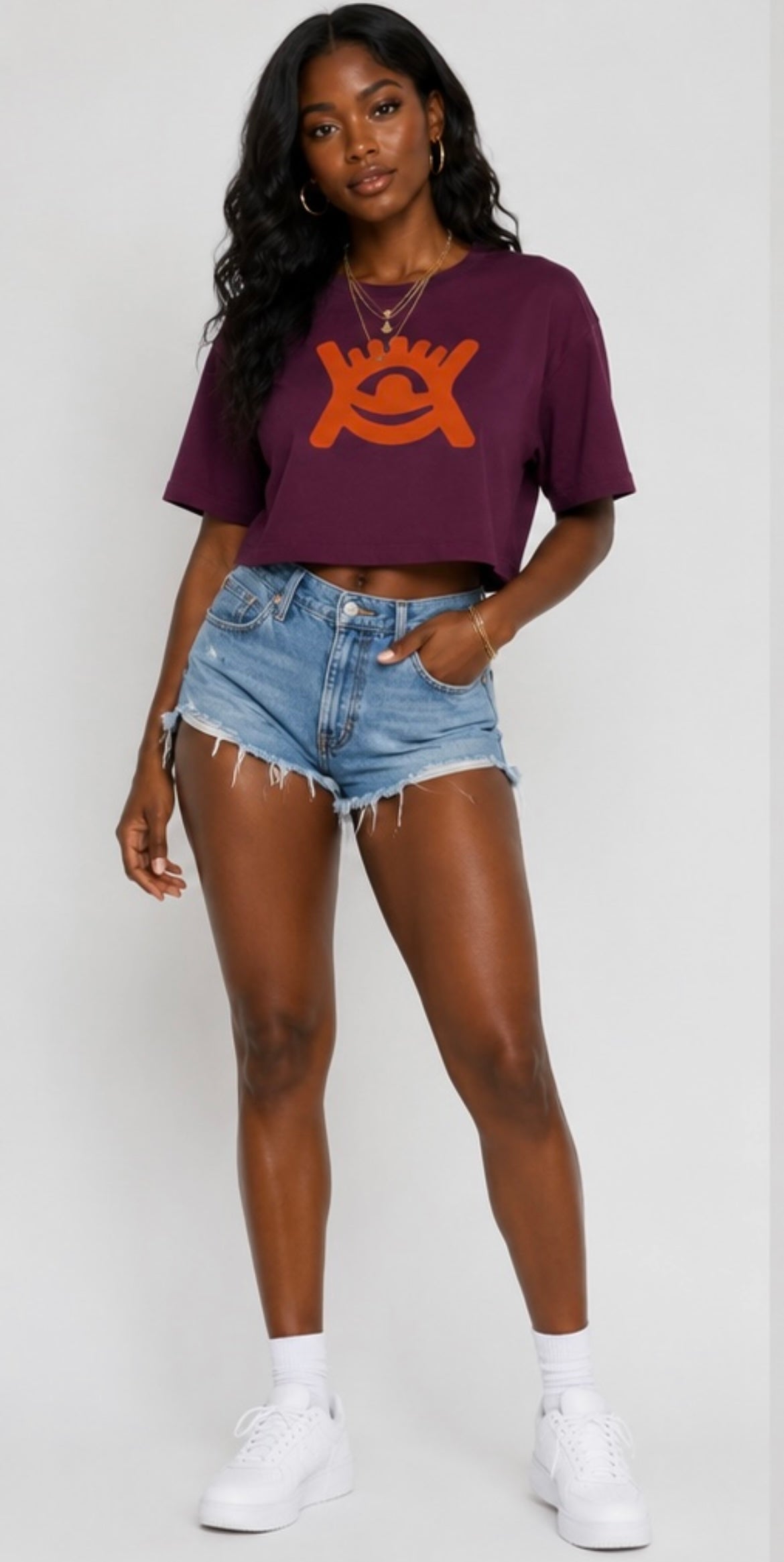 Model wearing Cotton quality cropped mulberry colour top | blue denim jeans and white trainers. 
