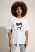 Person wearing a white t-shirt with a graphic design on a plain background