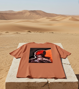 Brown t-shirt with a graphic design on a stone block in a desert setting