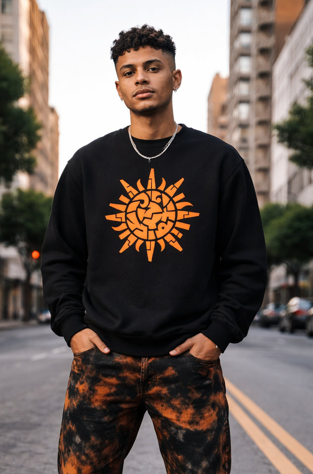 Person wearing a black sweatshirt with a sun design and camouflage pants on a city street.