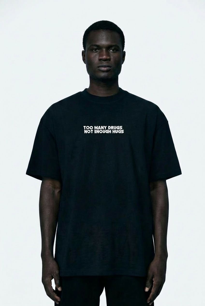 Person wearing a black t-shirt with text on a white background