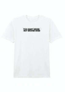 A gray cotton crew neck t-shirt with the text 'TOO MANY DRUGS NOT ENOUGH HUGS' printed on the front.