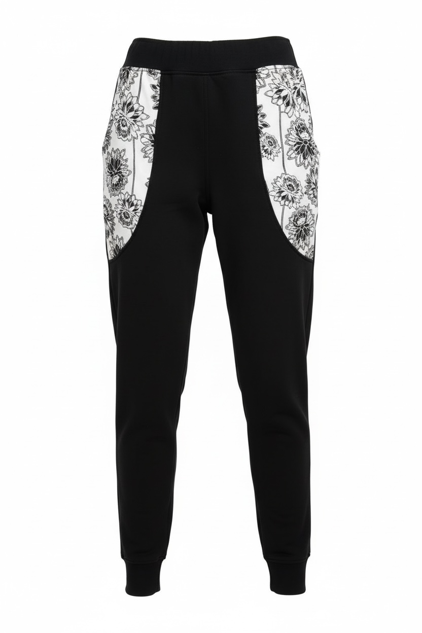 Black jogger pants with white floral patterns on a white background
