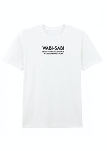 A white cotton T-shirt with the text 'WABI-SABI beauty and acceptance is in imperfection' printed on the front.
