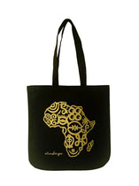 Black cotton tote bag with a gold Africa map outline design and the brand name 'Adinkra' printed on the front.