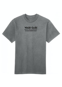 A white cotton T-shirt with the text 'WABI-SABI beauty and acceptance is in imperfection' printed on the front.