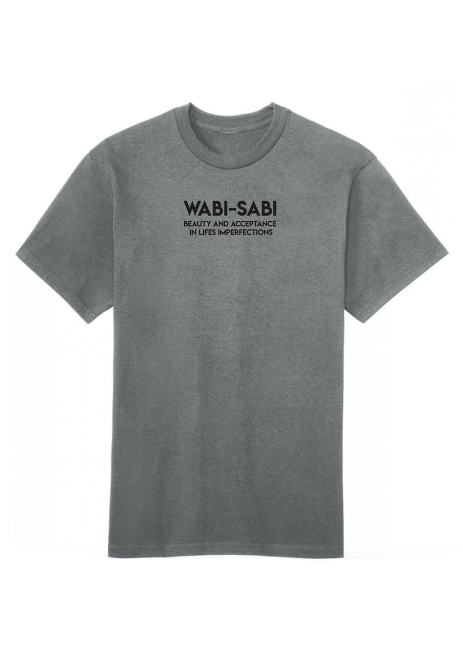 A white cotton T-shirt with the text 'WABI-SABI beauty and acceptance is in imperfection' printed on the front.